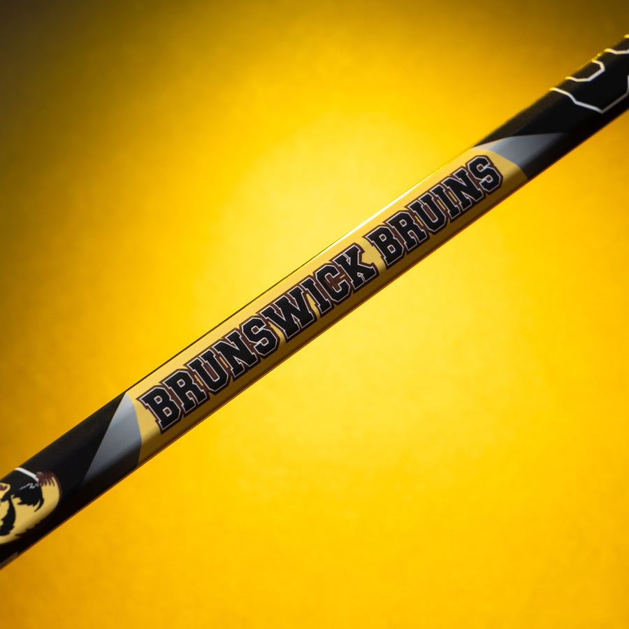 Brunswick Bruins team name printed on a sample mini lacrosse stick shaft